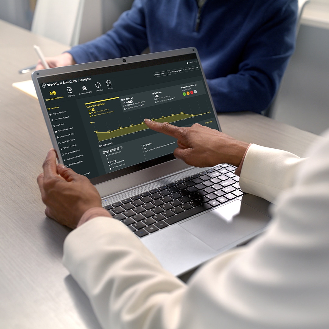 Technician using a laptop to review workflow optimization